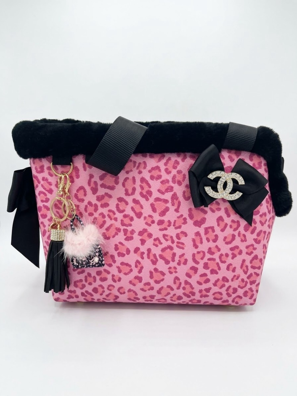 Pink Leopard-Print Pet Carrier with Black Fur Trim and Bow Accent. DOGS NOT INC